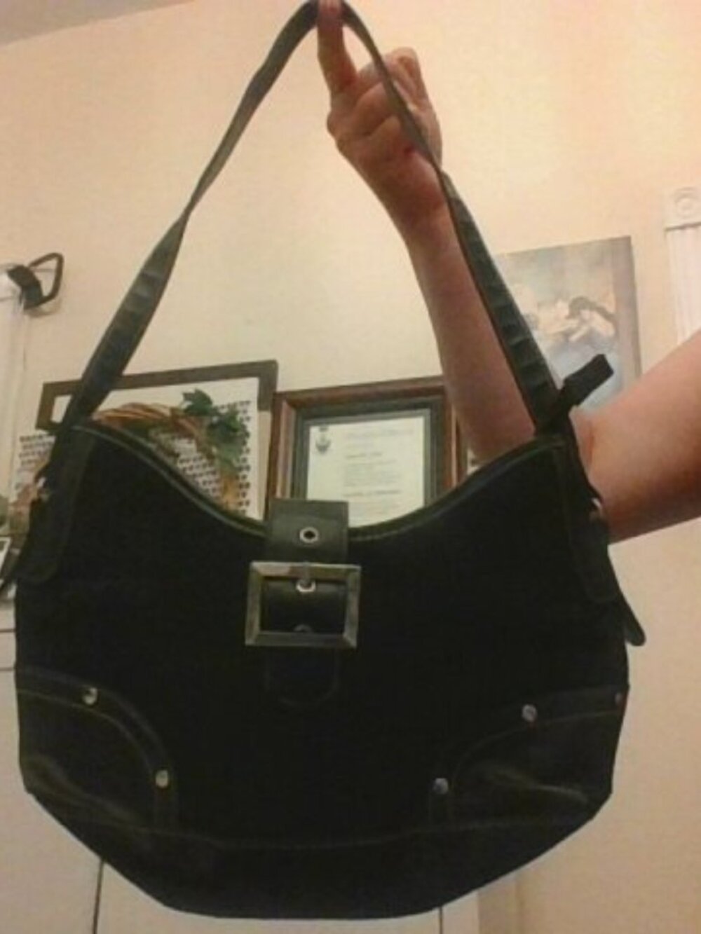 purse black with a front strap and zippered close